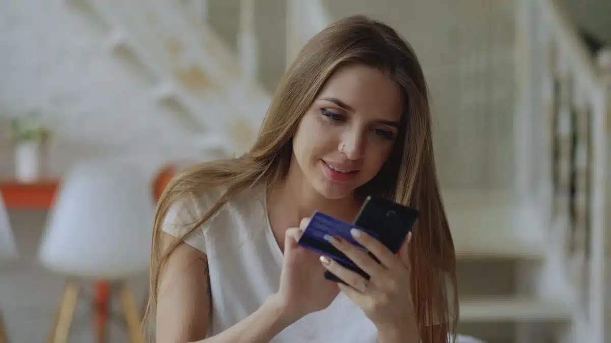 Joven usando una aplicación de finanzas en el celular, representando el acceso a créditos digitales.